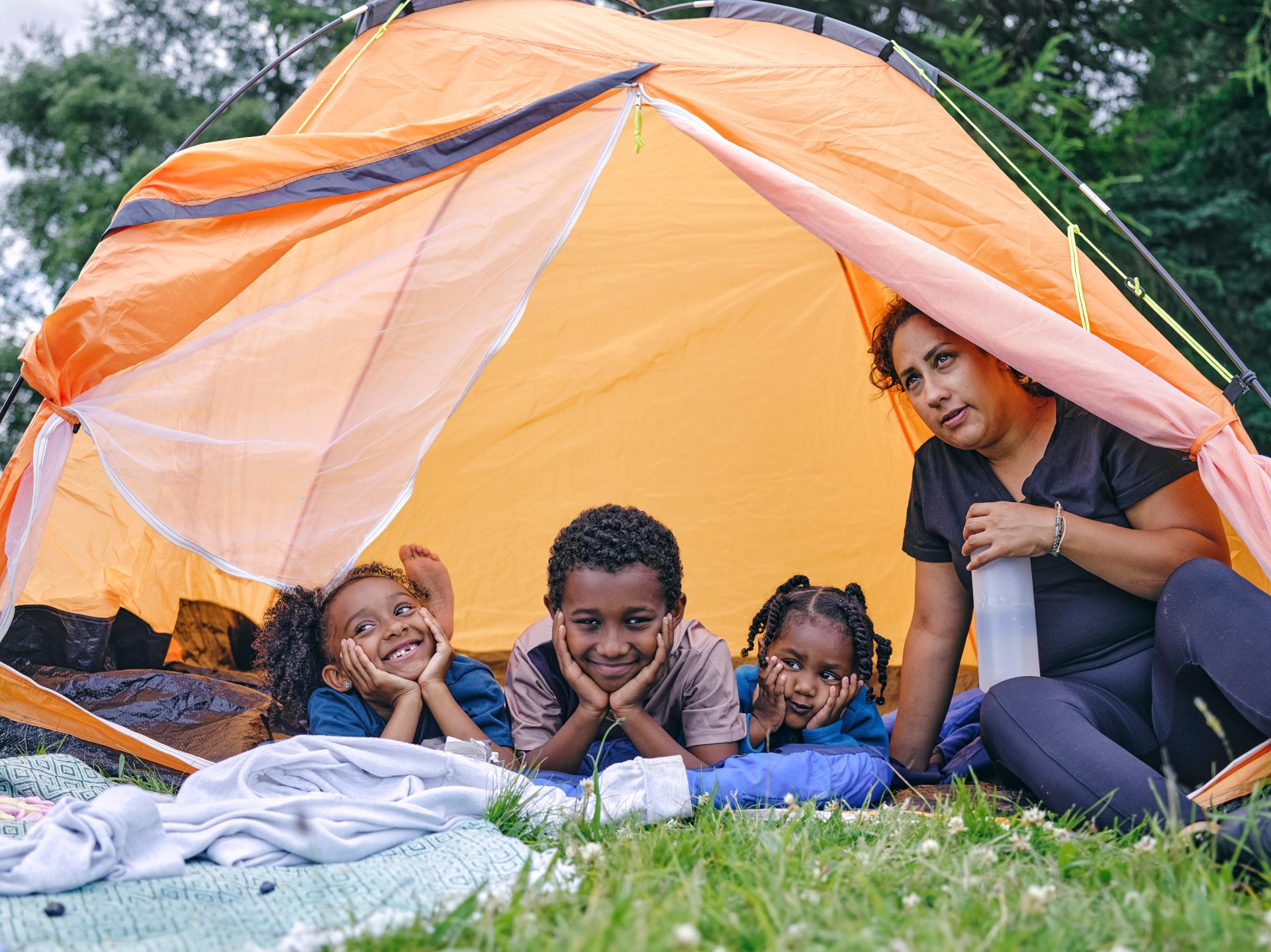 family sitting in tent