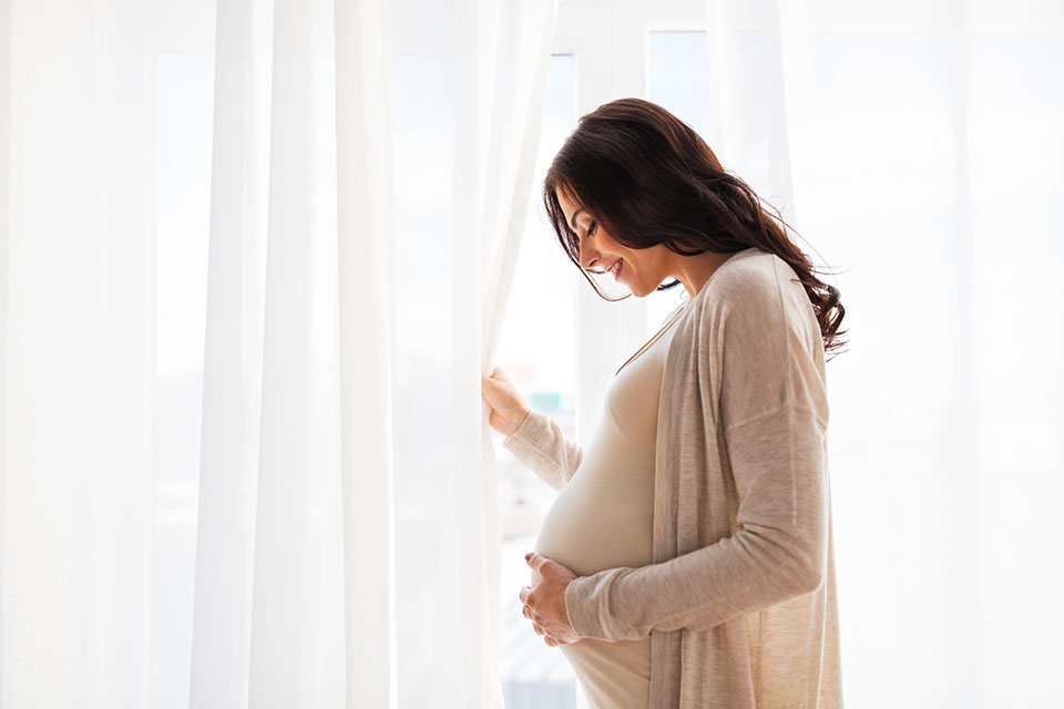 pregnant mother resting hand on stomach