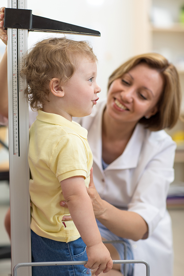 healthcare professional measuring child's height